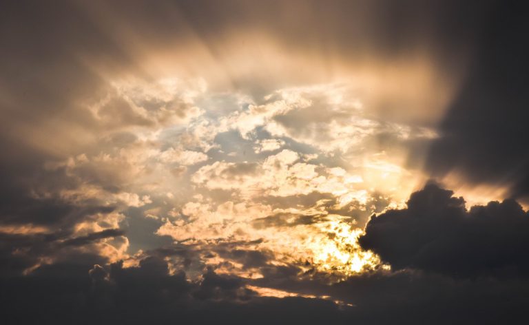Sun pierces through cloudy skies